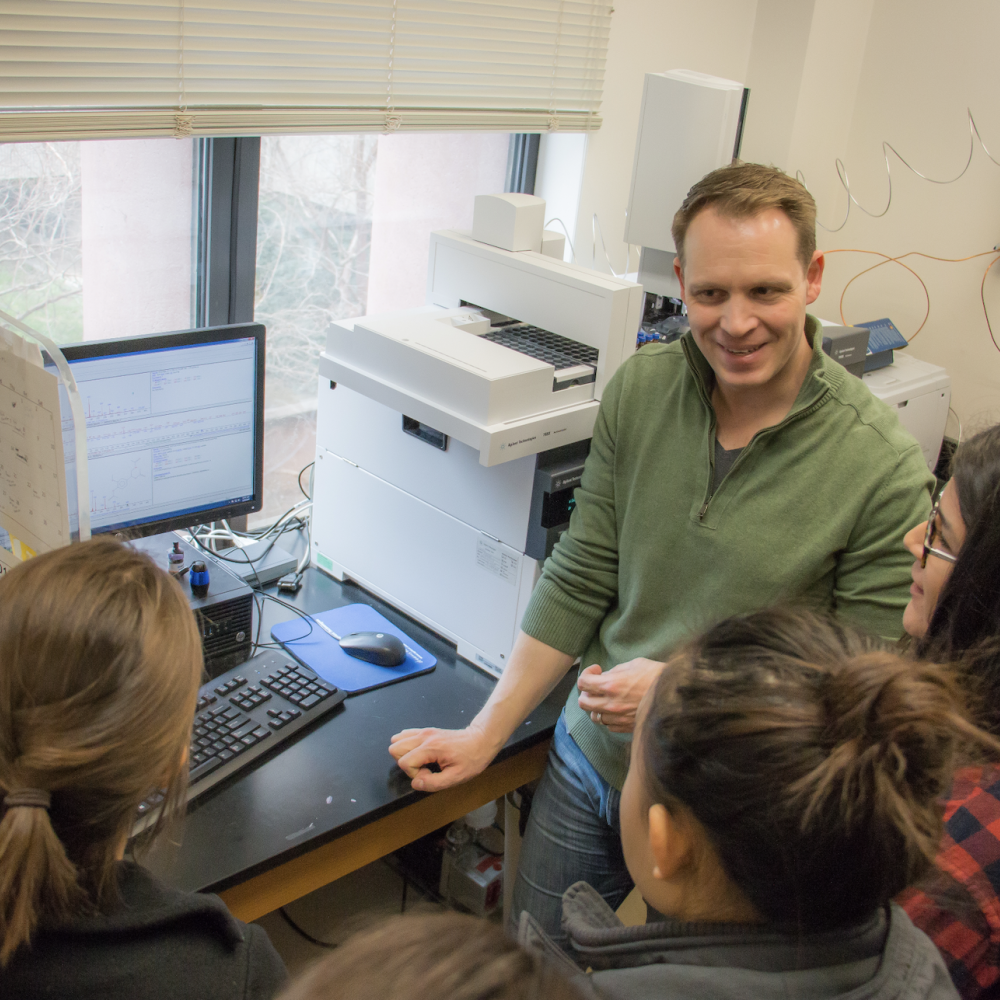 Zerbe teaching lab members around laptop